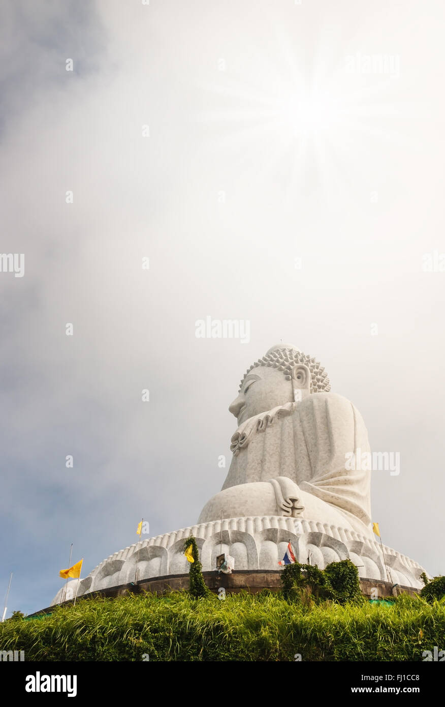 Big buddha in blurred sky and over light the sun, It is public in Thailand Stock Photo
