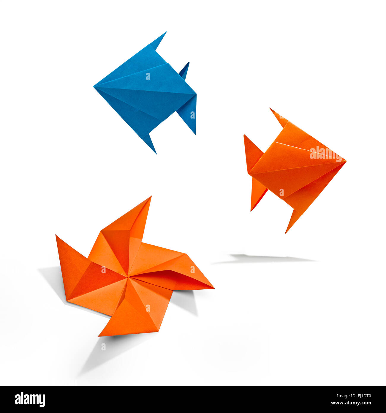 Group of swimming fishs in Origami, there is a path for each bird. Stock Photo