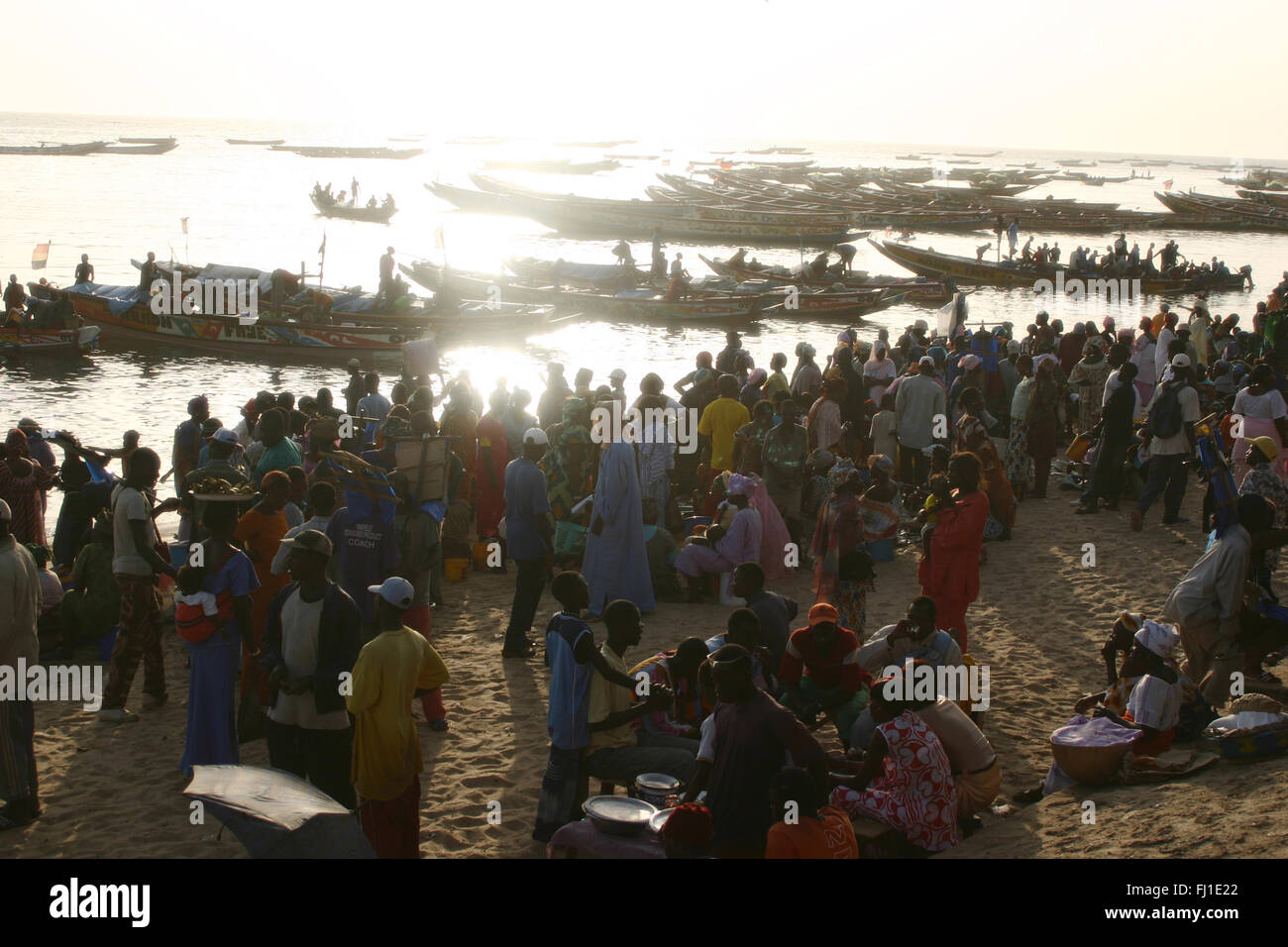 Mbour harbor on a late afternoon with crowd and fresh fish market , landscape , Senegal Stock Photo