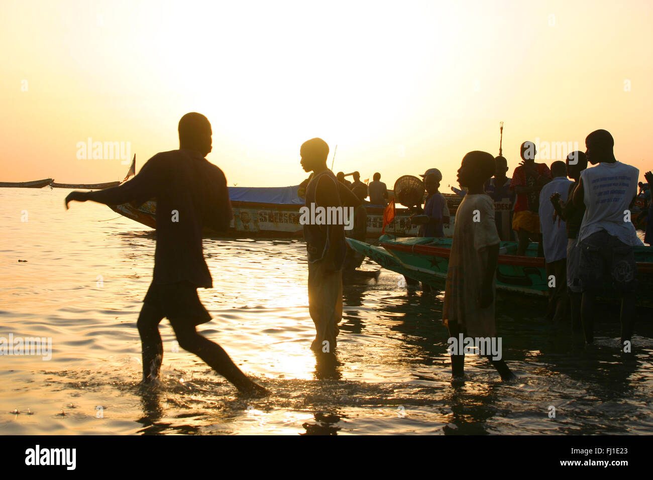 Mbour harbor on a late afternoon with crowd and fresh fish market , landscape , Senegal Stock Photo