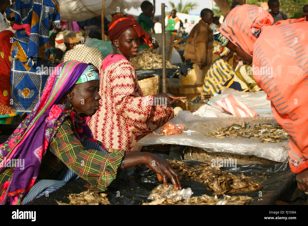 Typical market day scene in Segou , mali, with woman selling fish with traditional African clothes Stock Photo