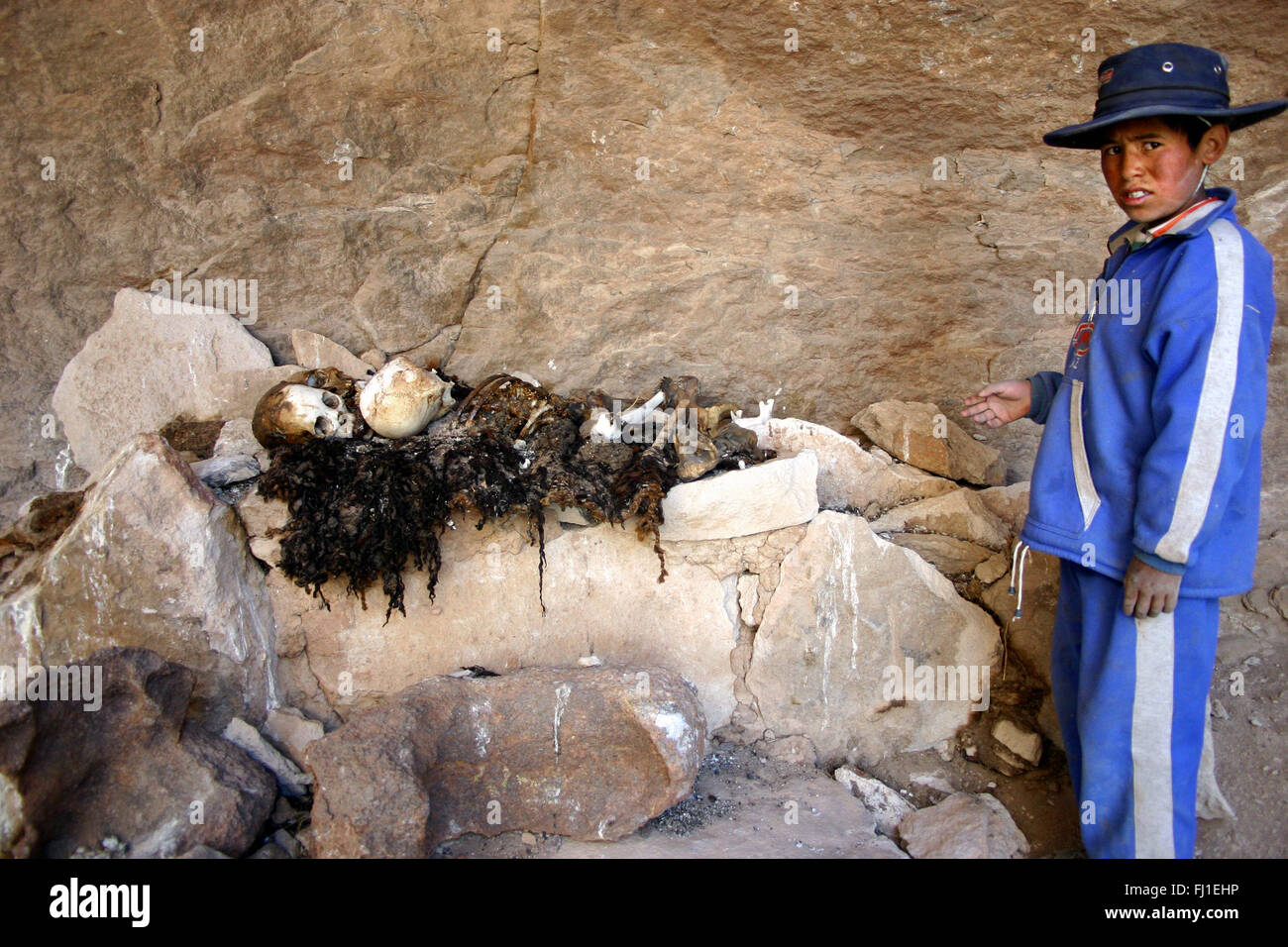 Kid showind mummy , dead body , humain remains  of ancestors in Villa Mar, Bolivia Stock Photo