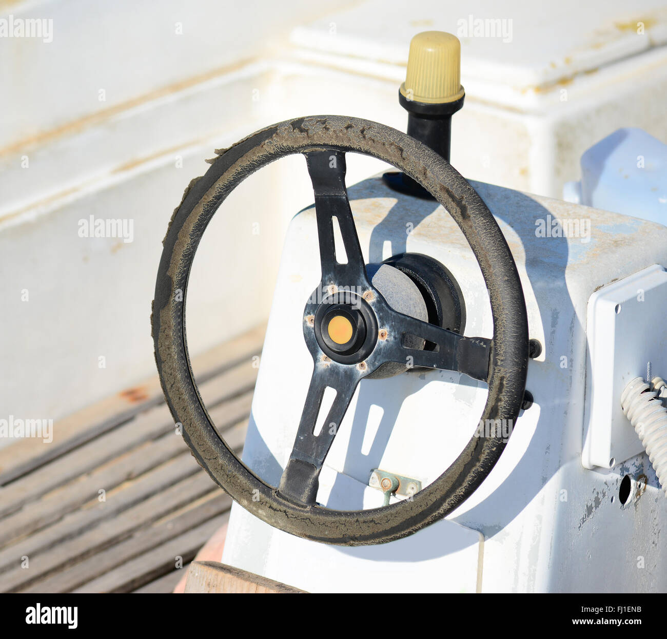 old steering wheel in a white boat Stock Photo Alamy