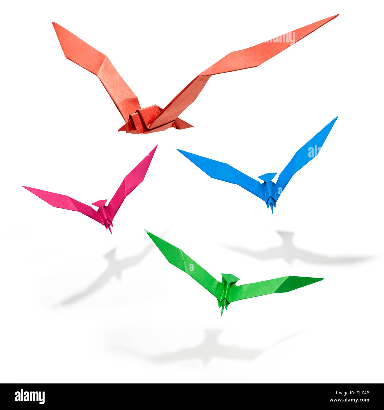 Group of flying birds in Origami, there is a path for each bird. Stock Photo