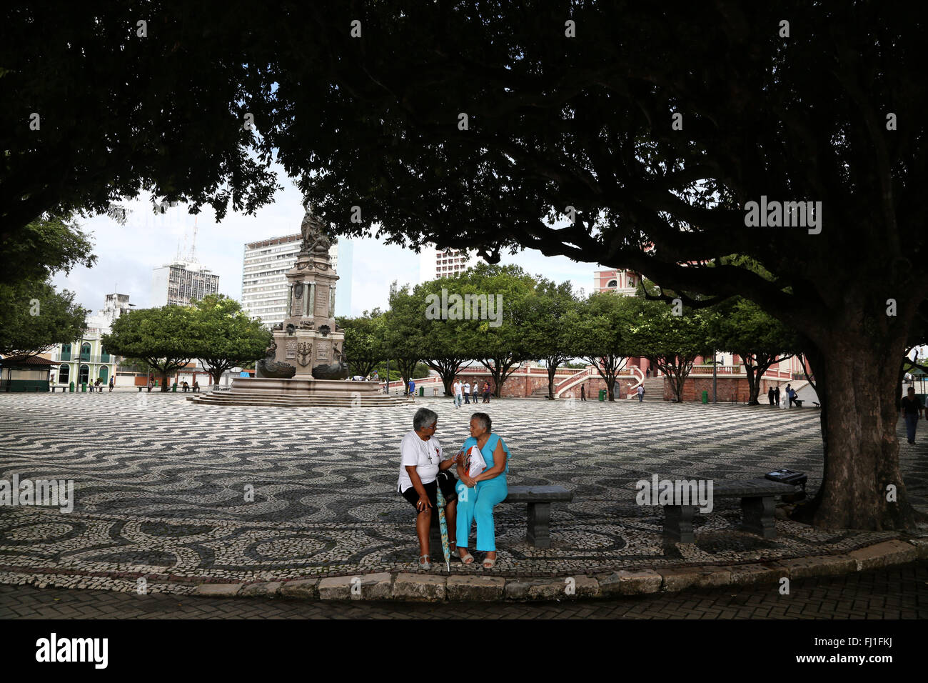 Two ladies sitting on a bench on San Sebastian Square , center of Manaus, Brazil Stock Photo