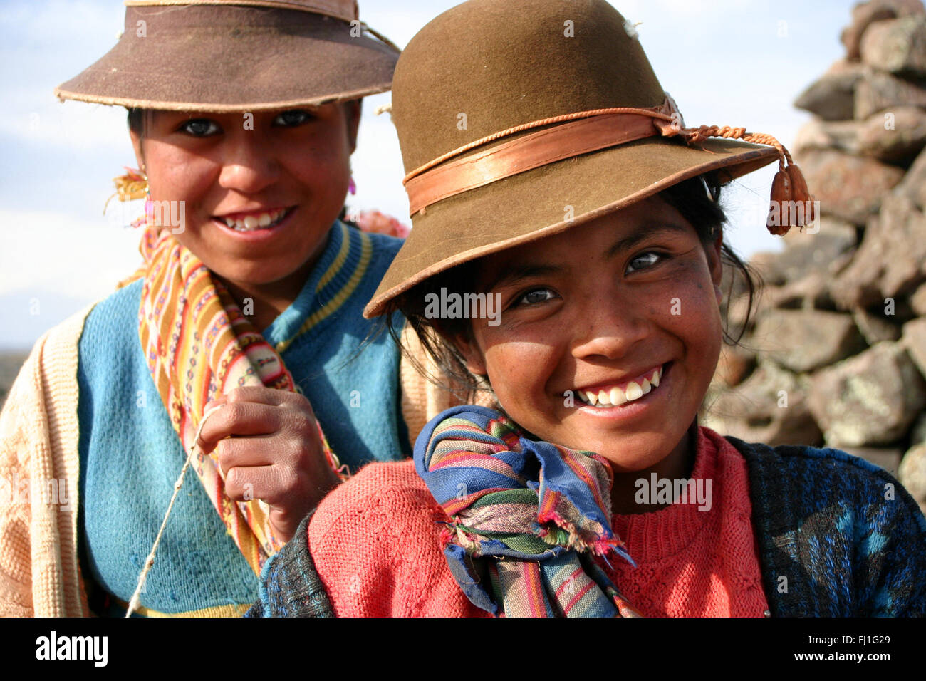 Smiling Peruvian girls in Sillustani , Peru Stock Photo