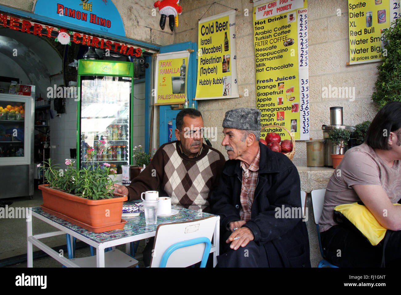 Two men are talking in a café restaurant near Damascus gate in the old part of Jerusalem , Israel Stock Photo