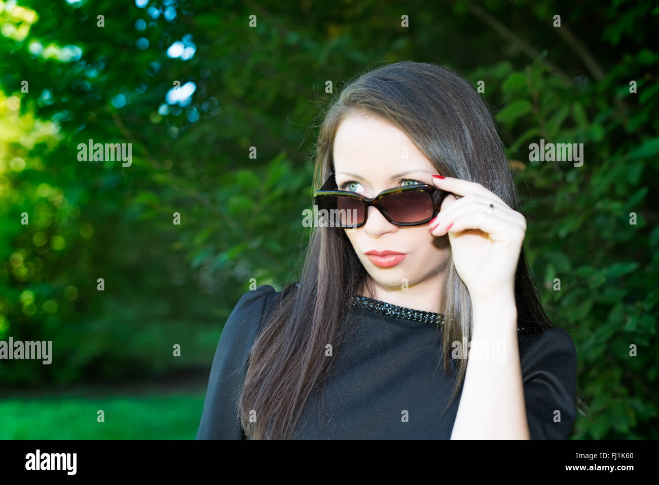 Portrait of young attractive girl with sunglasses in the park Stock ...