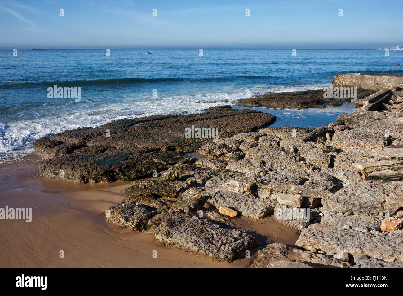 Old corroded stones at the Atlantic Ocean shore in Portugal Stock Photo