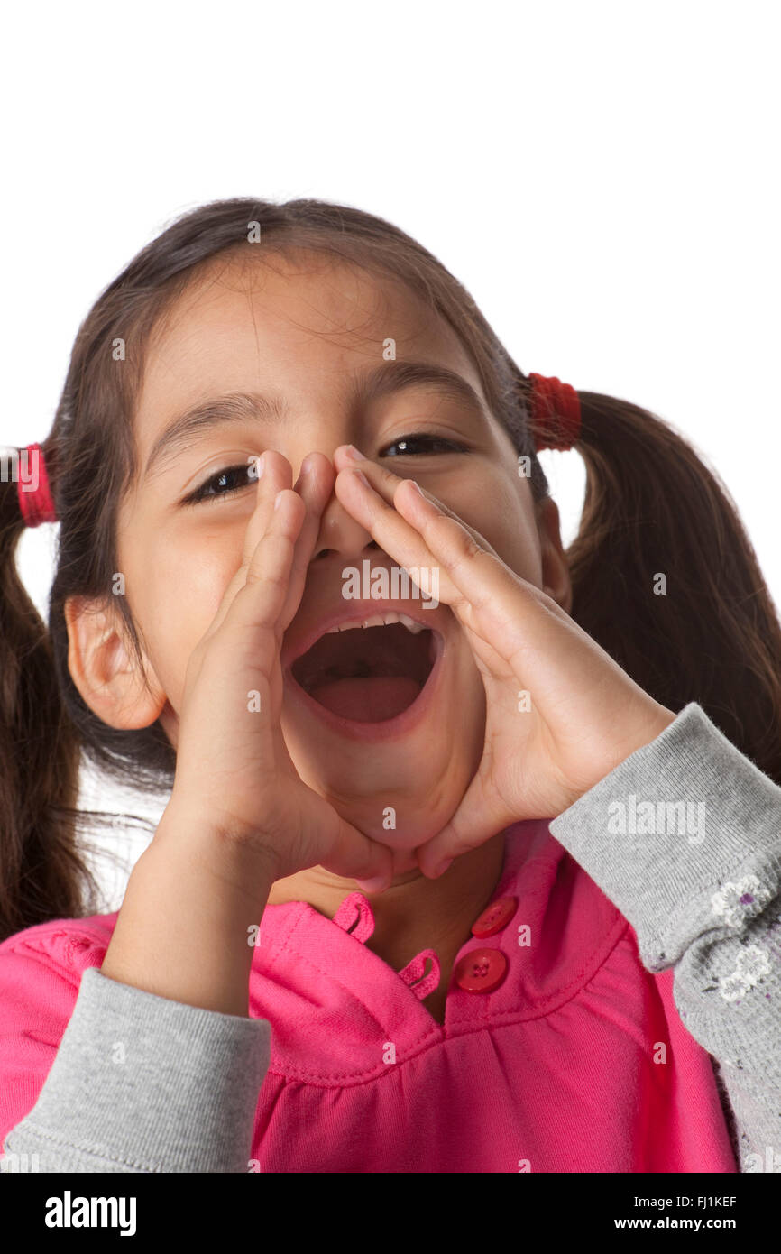 Little girl is screaming with her fingers around her mouth on white background Stock Photo