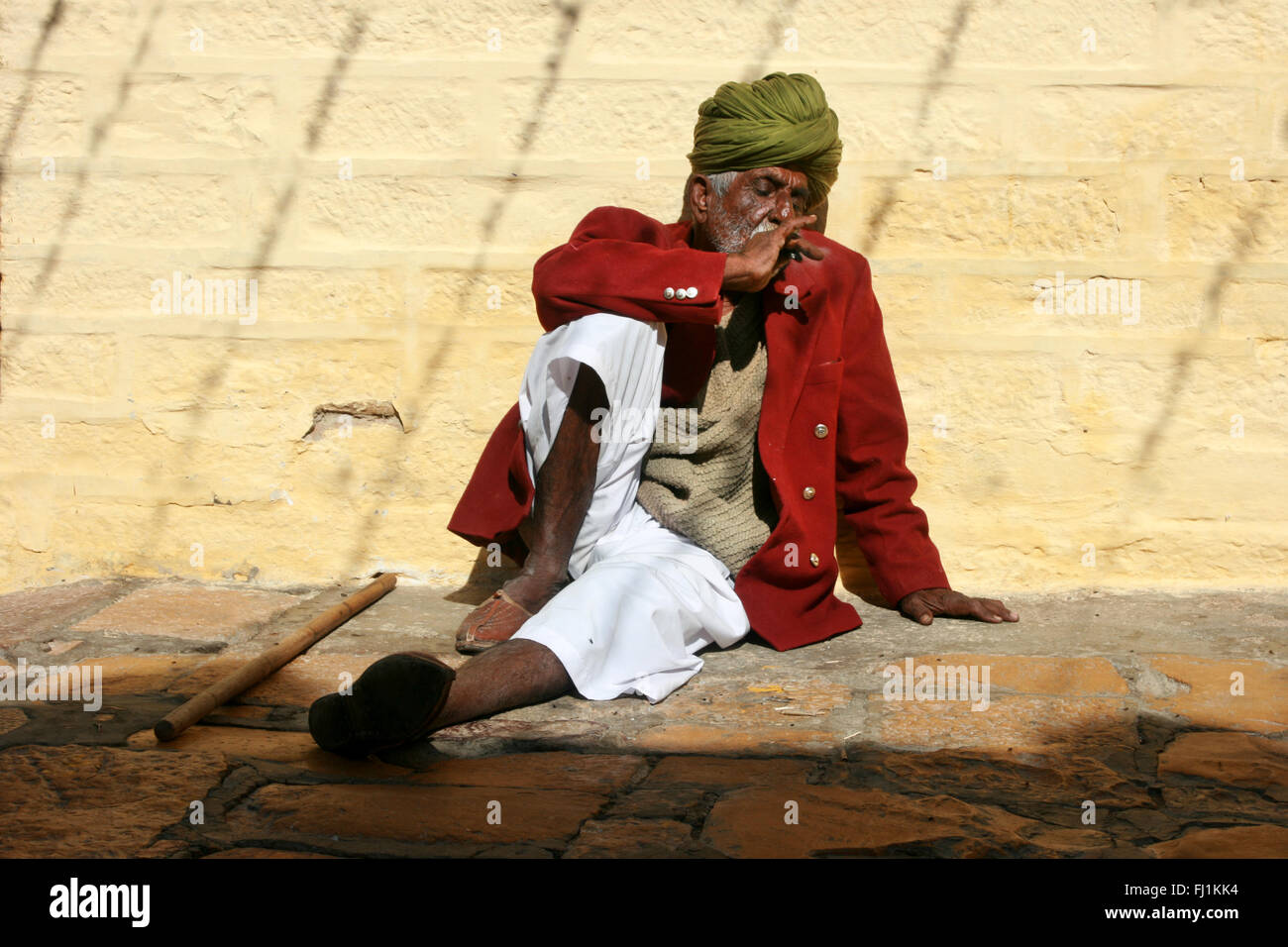 Rajasthani man with turban smoking in jaisalmer fort , India Stock Photo