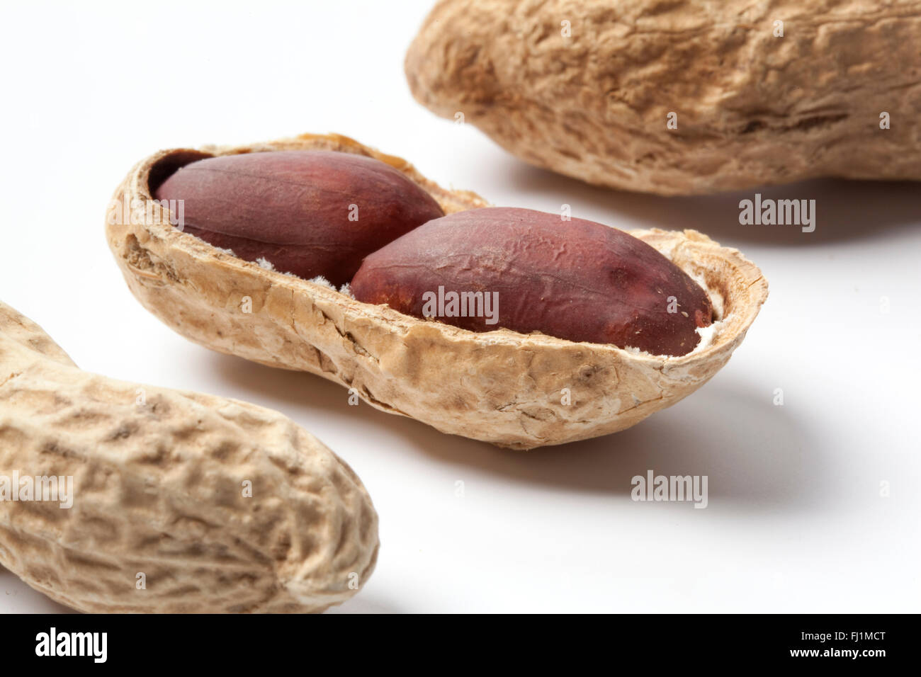 Peeled peanuts on white background Stock Photo