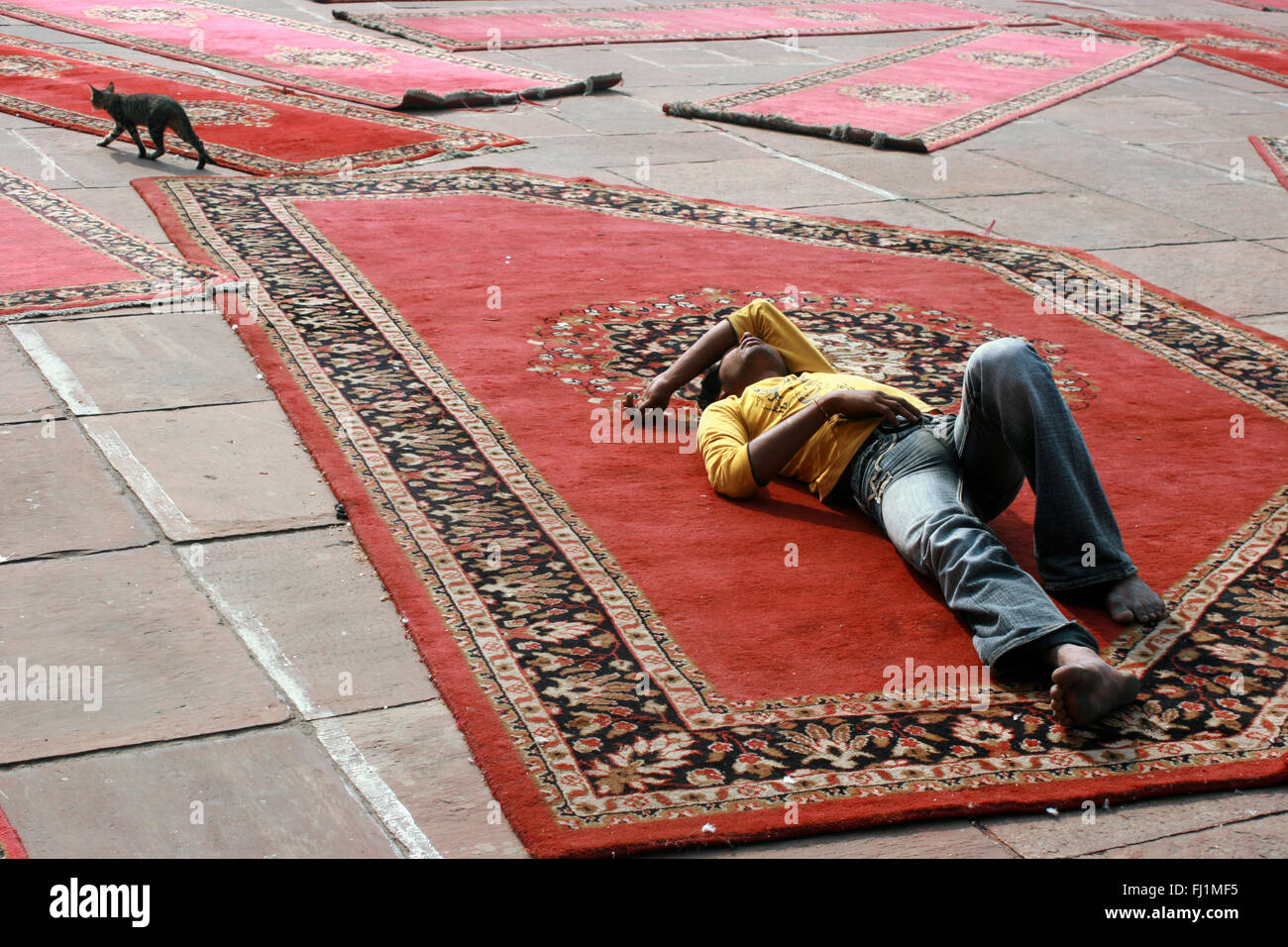 Muslim man sleeping on carpet at jama Masjid (great mosque) of Old Delhi , India Stock Photo