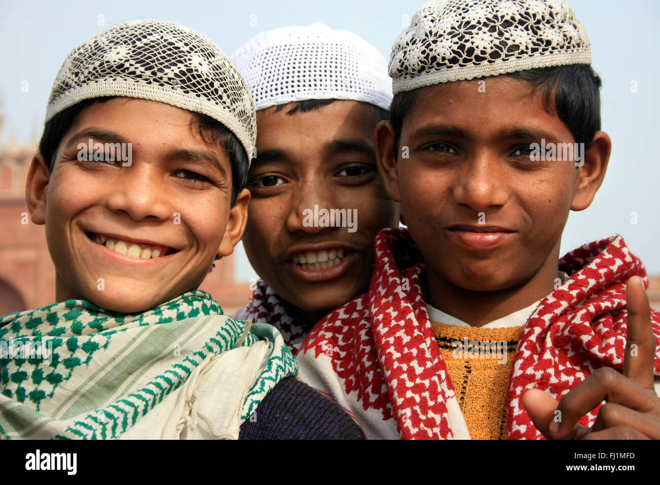 Three Muslim guys at mosque Jama masjid , Old Delhi , India Stock Photo