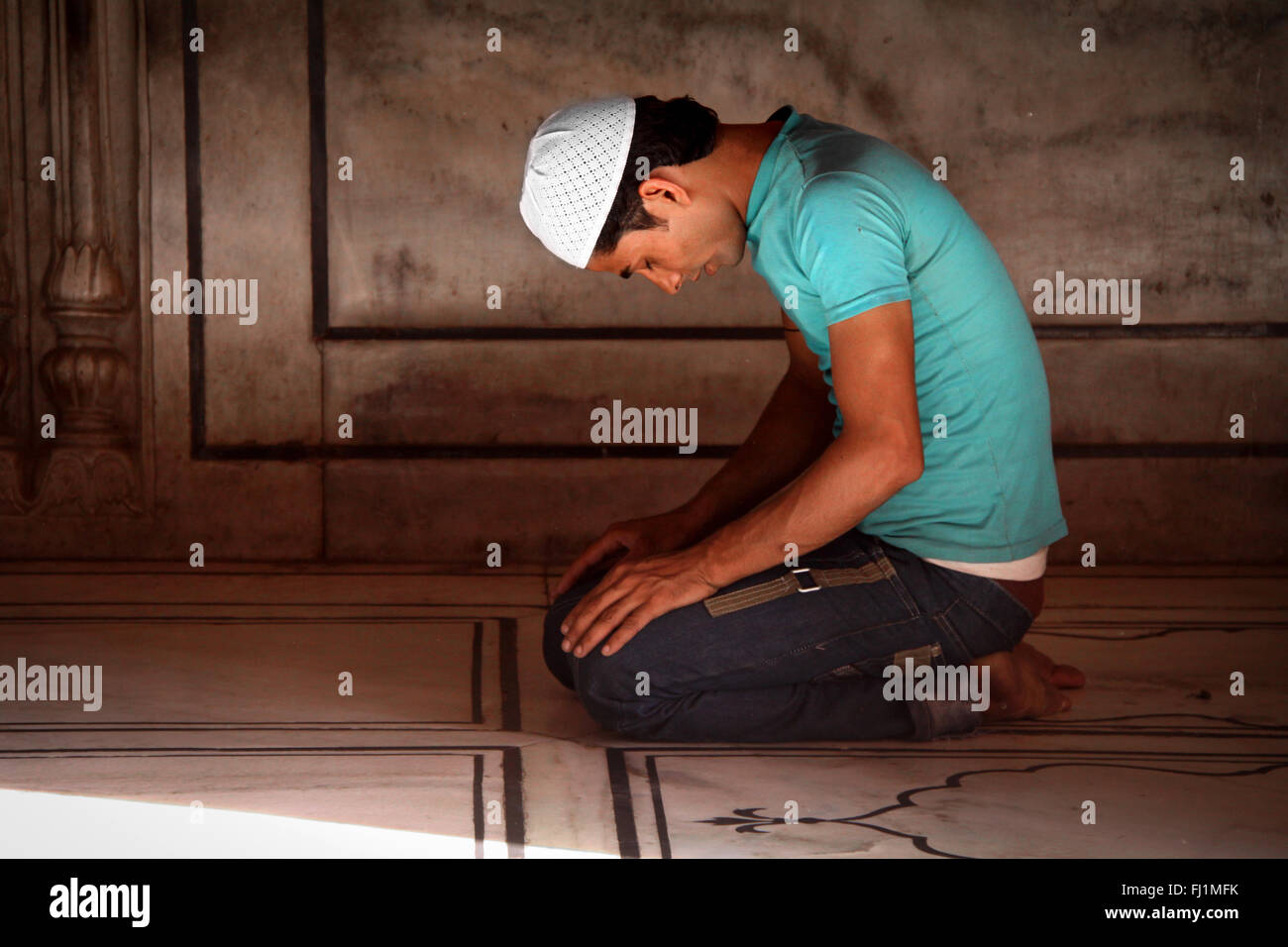 Muslim man praying at jama Masjid (great mosque) of Old Delhi , India Stock Photo