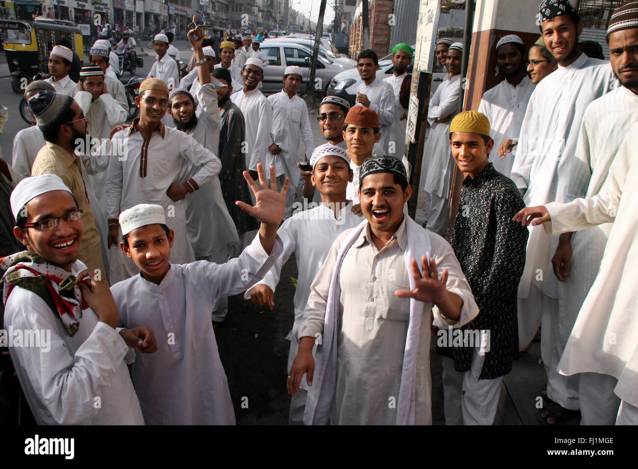A group of happy and smiling Muslim guys with traditional costumes stand in a street of Jodhpur, India Stock Photo