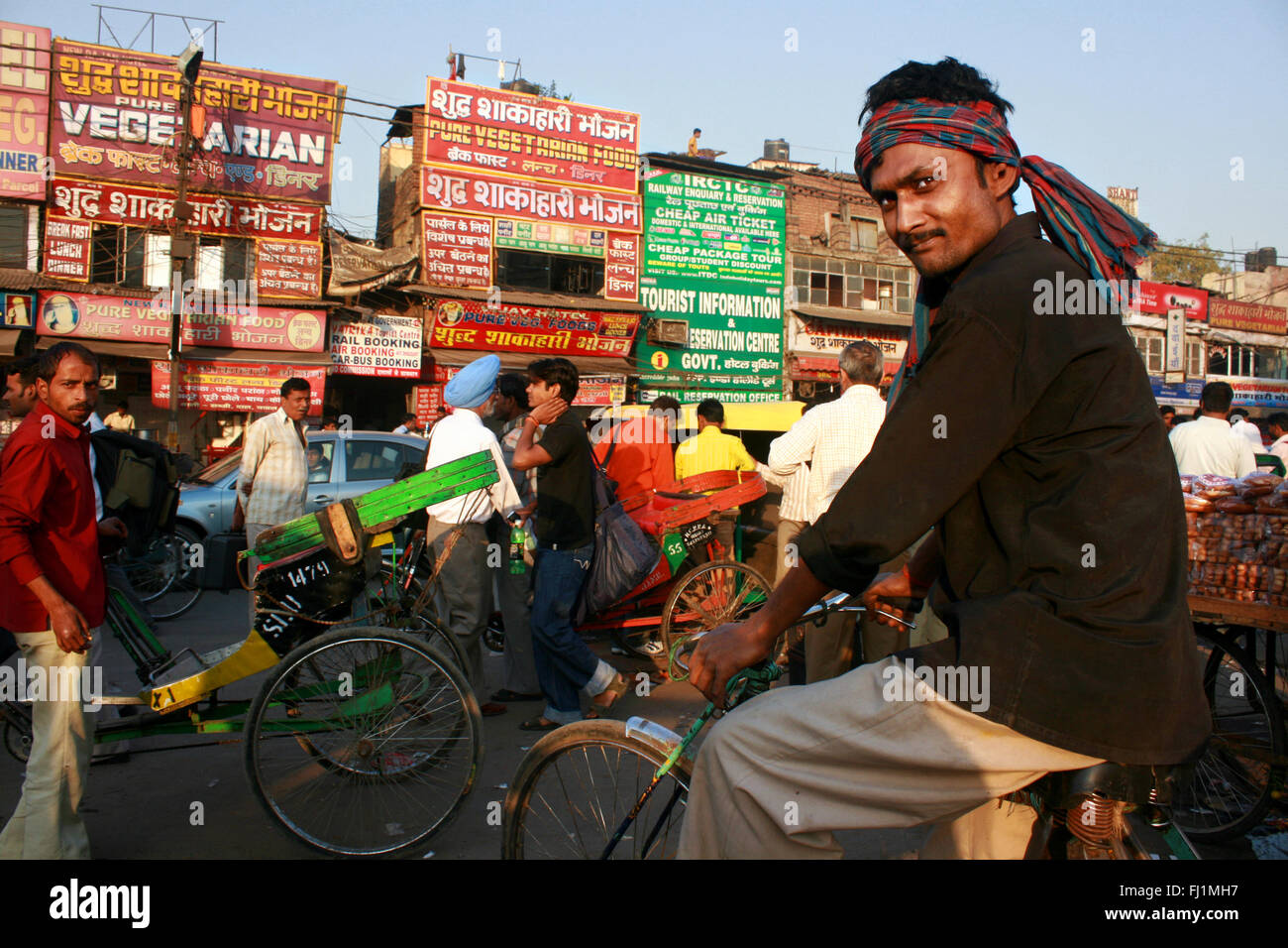 Cyclo Rickshaw driver in a street in Delhi, India Stock Photo