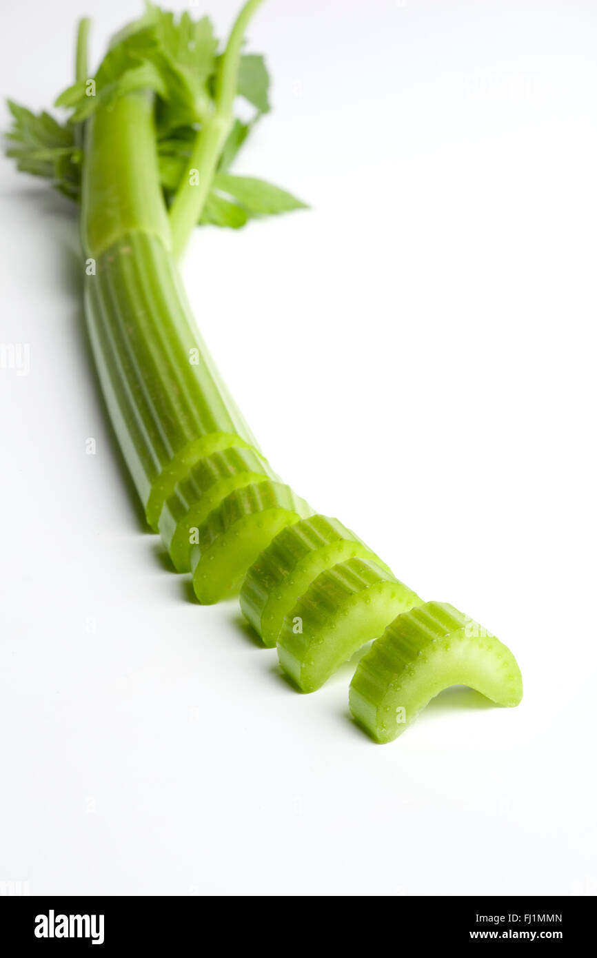 Fresh raw Celery stem cut into pieces on white background Stock Photo