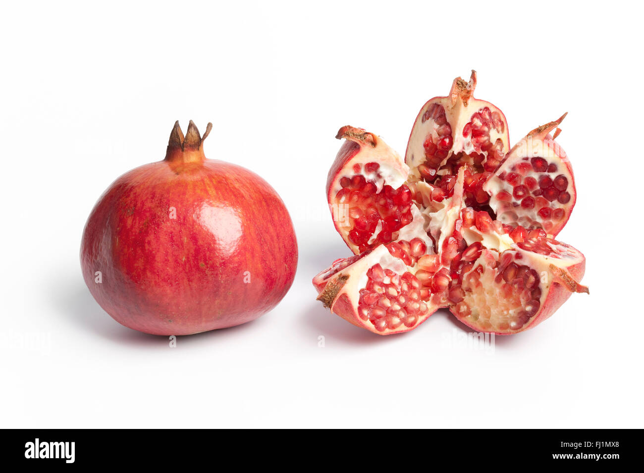 Whole and open Pomegranate, Punica Granatum, on white background Stock Photo