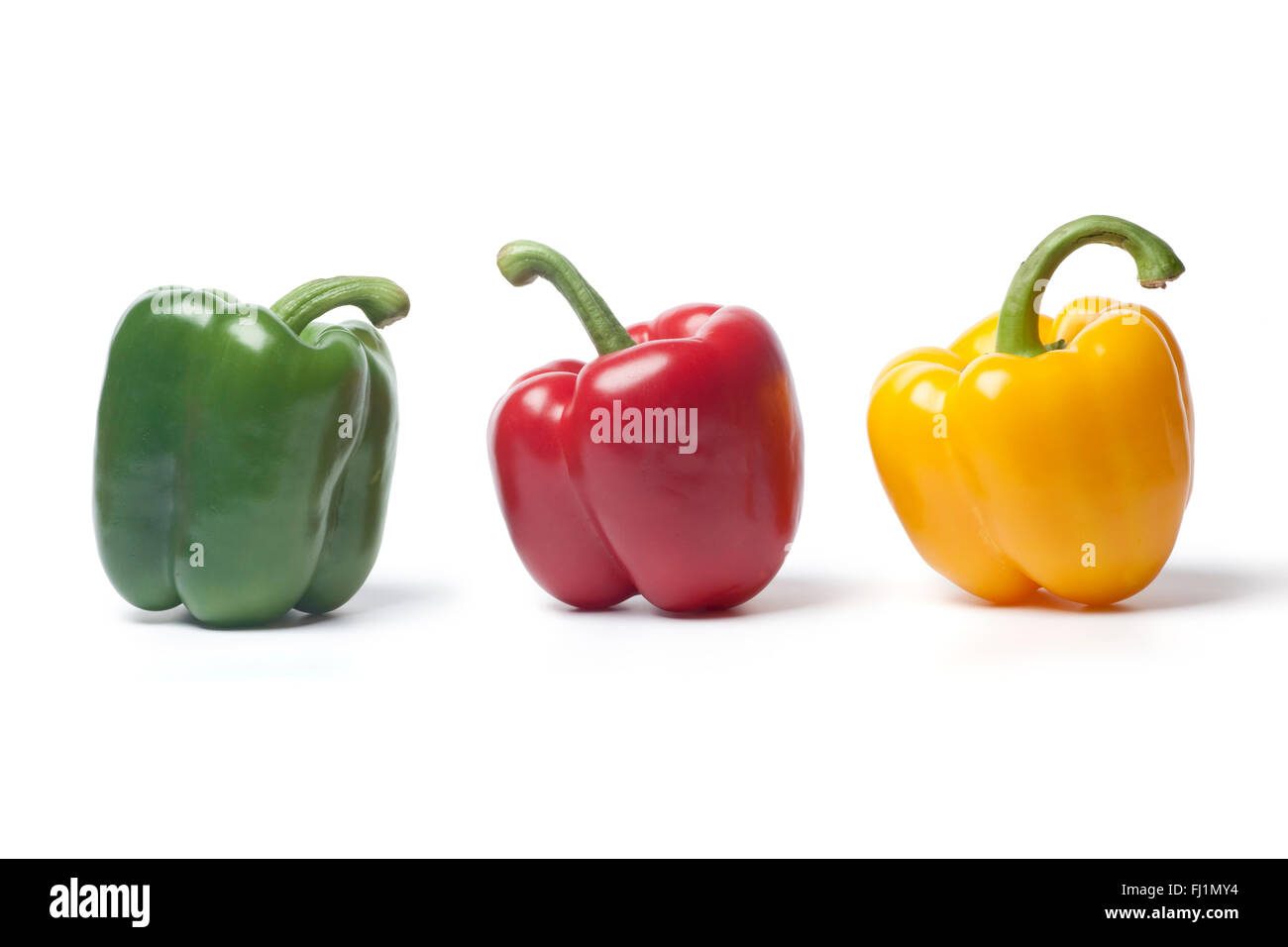 Fresh red,green,yellow bell pepper on a row on white background Stock Photo