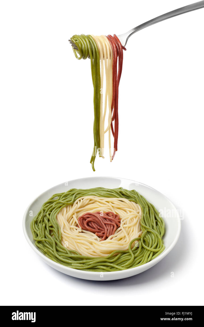 Dish and fork with cooked Spaghetti tricolore on white background Stock ...