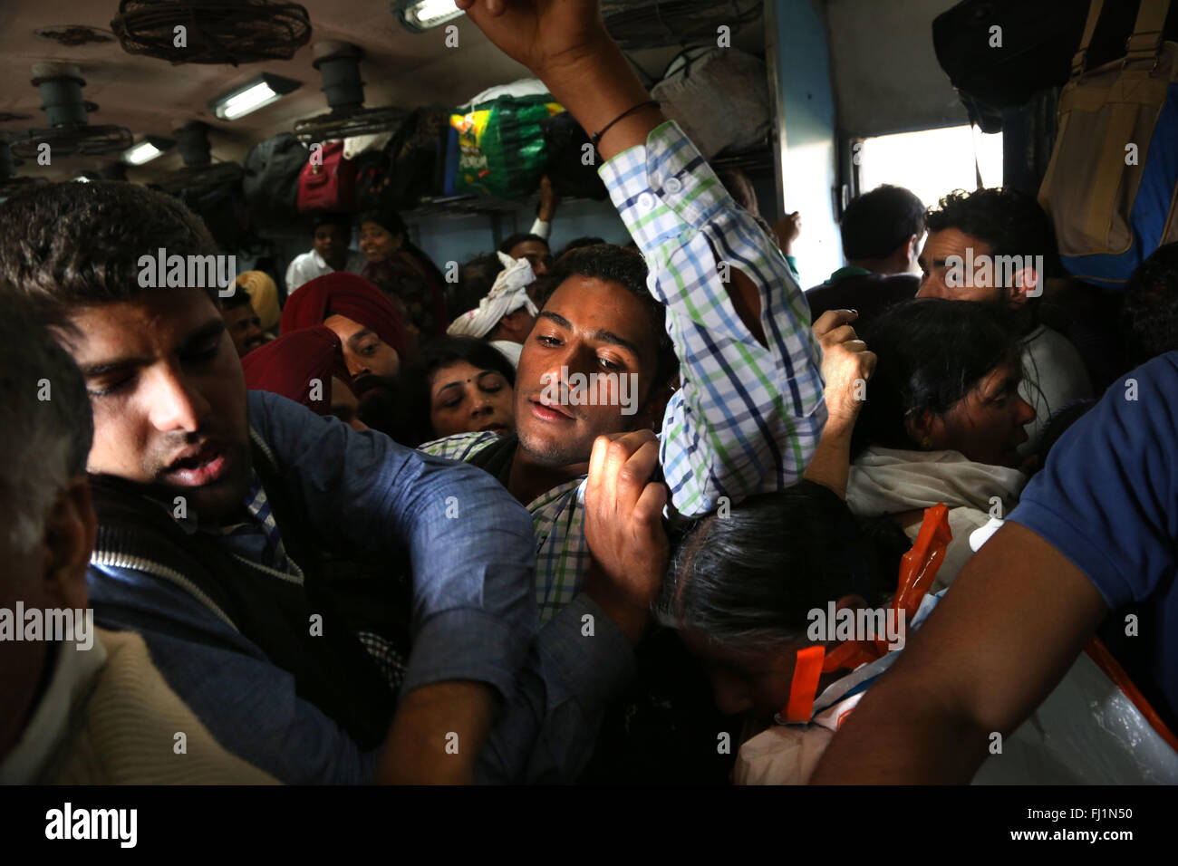 Passengers travel in an overcrowded train from Delhi to Amritsar , India Stock Photo