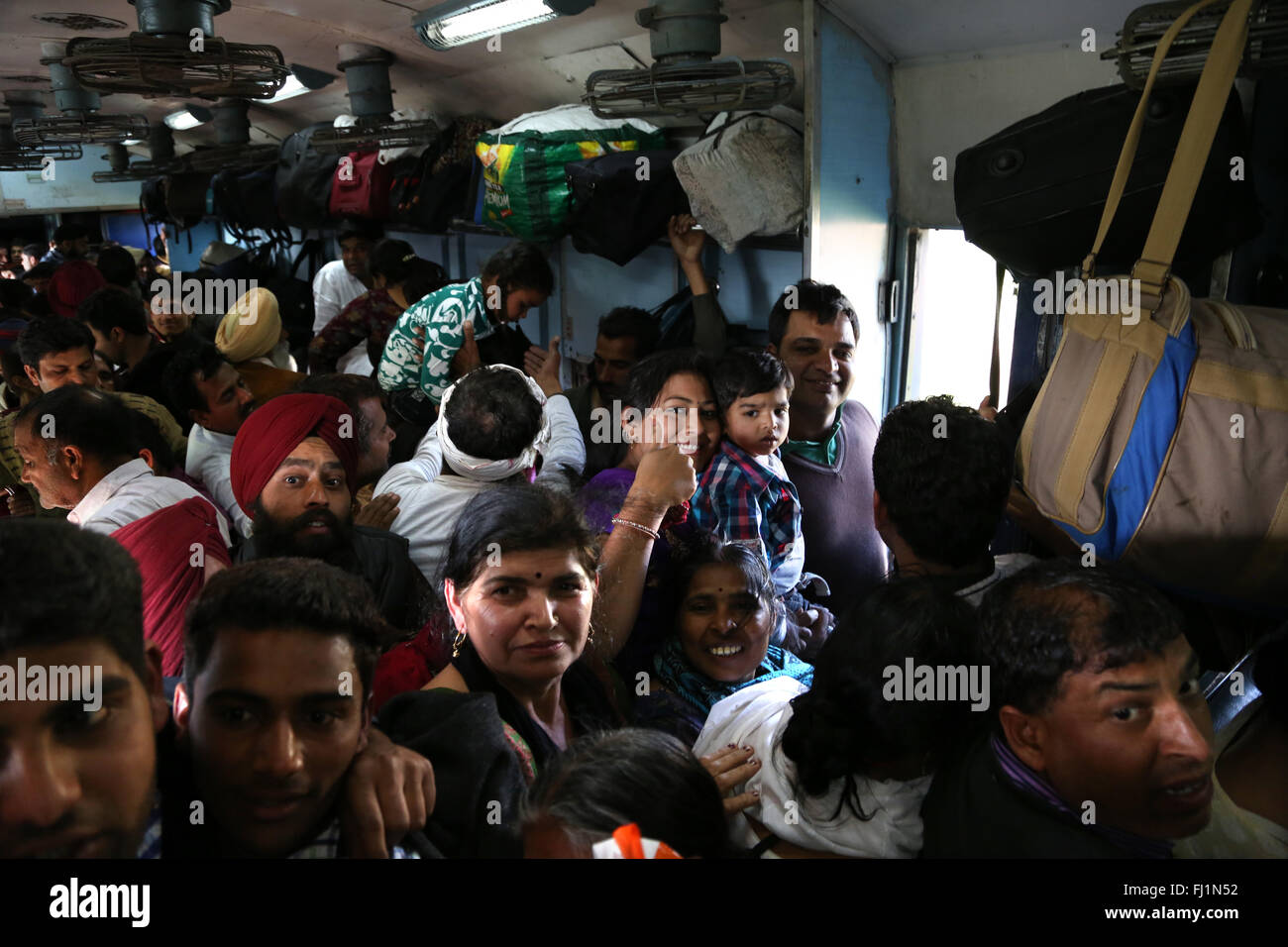 Passengers travel in an overcrowded train from Delhi to Amritsar , India Stock Photo