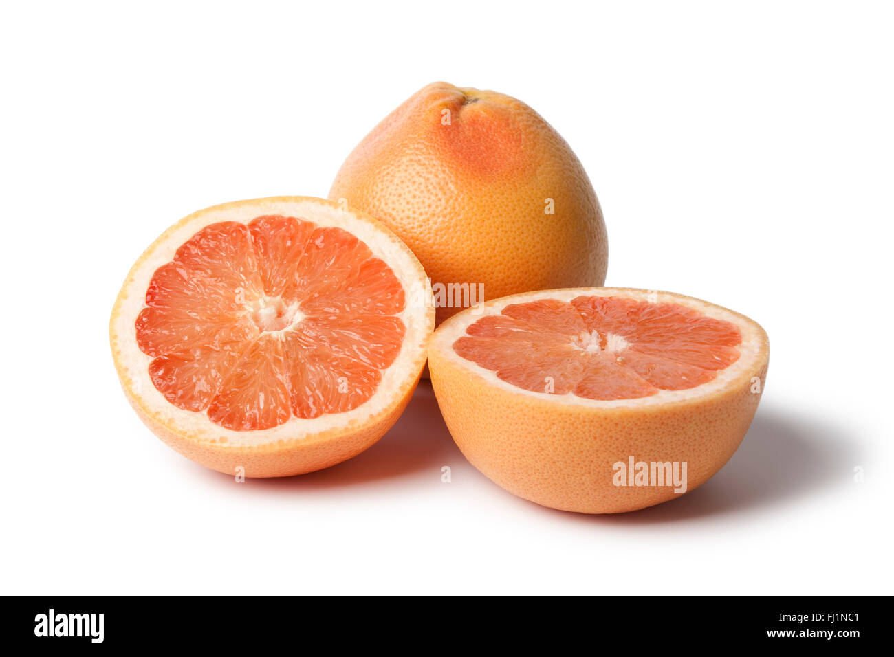 Whole and half fresh grapefruit on white background Stock Photo