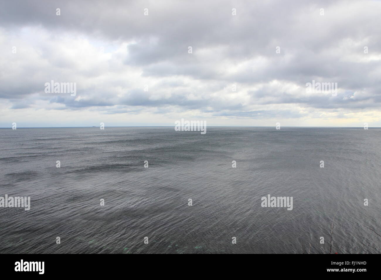 Ocean Horizon with Black Water and Dramatic Clouds Background Stock Photo