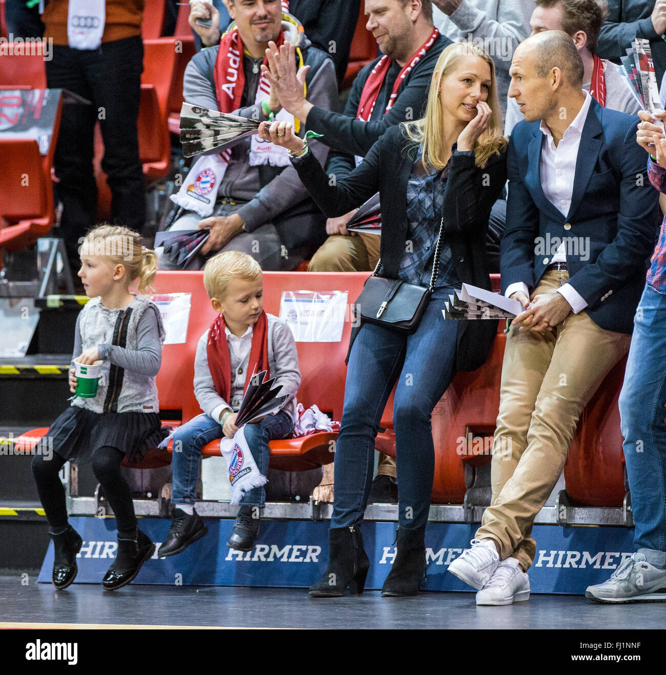 Munich, Germany. 28th Feb, 2016. FC Bayern Munich soccer player Arjen Robben, his wife Bernadien Eillert and two of their children sit in the stands at the German Bundesliga basketball game between Bayern Munich and ALBA Berlin in the Audi Dome in Munich, Germany, 28 February 2016. Photo: MARC MUELLER/dpa/Alamy Live News Stock Photo