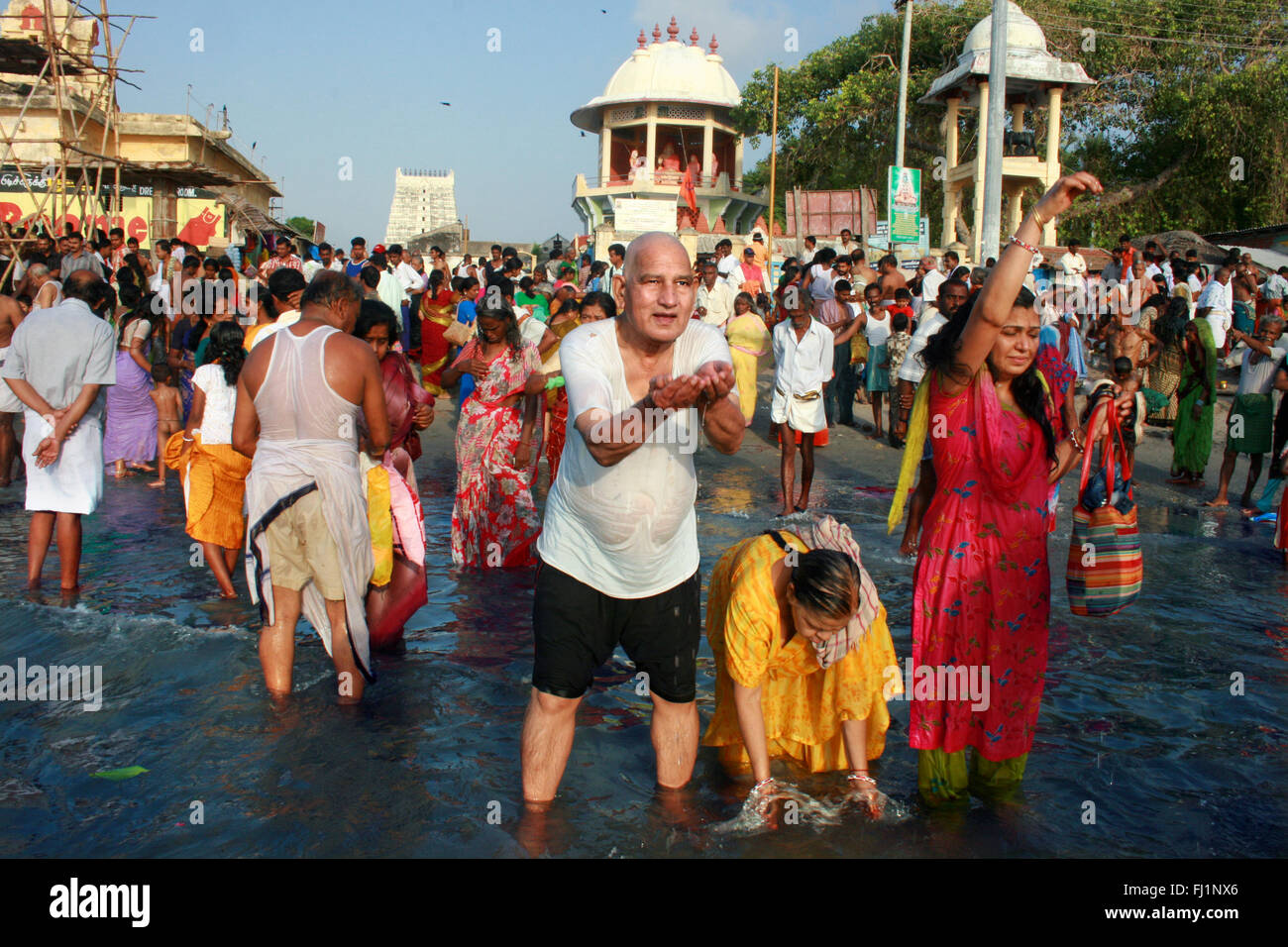 Pilgrims are making puja in the early morning in the holy waters of the ocean near holy city Rameswaram , Tamil Nadu , India Stock Photo