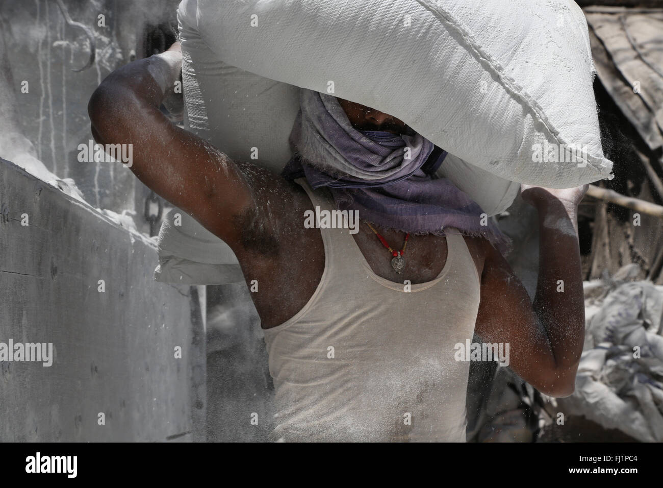 Worker carrying heavy cement bag in Kolkata , India Stock Photo