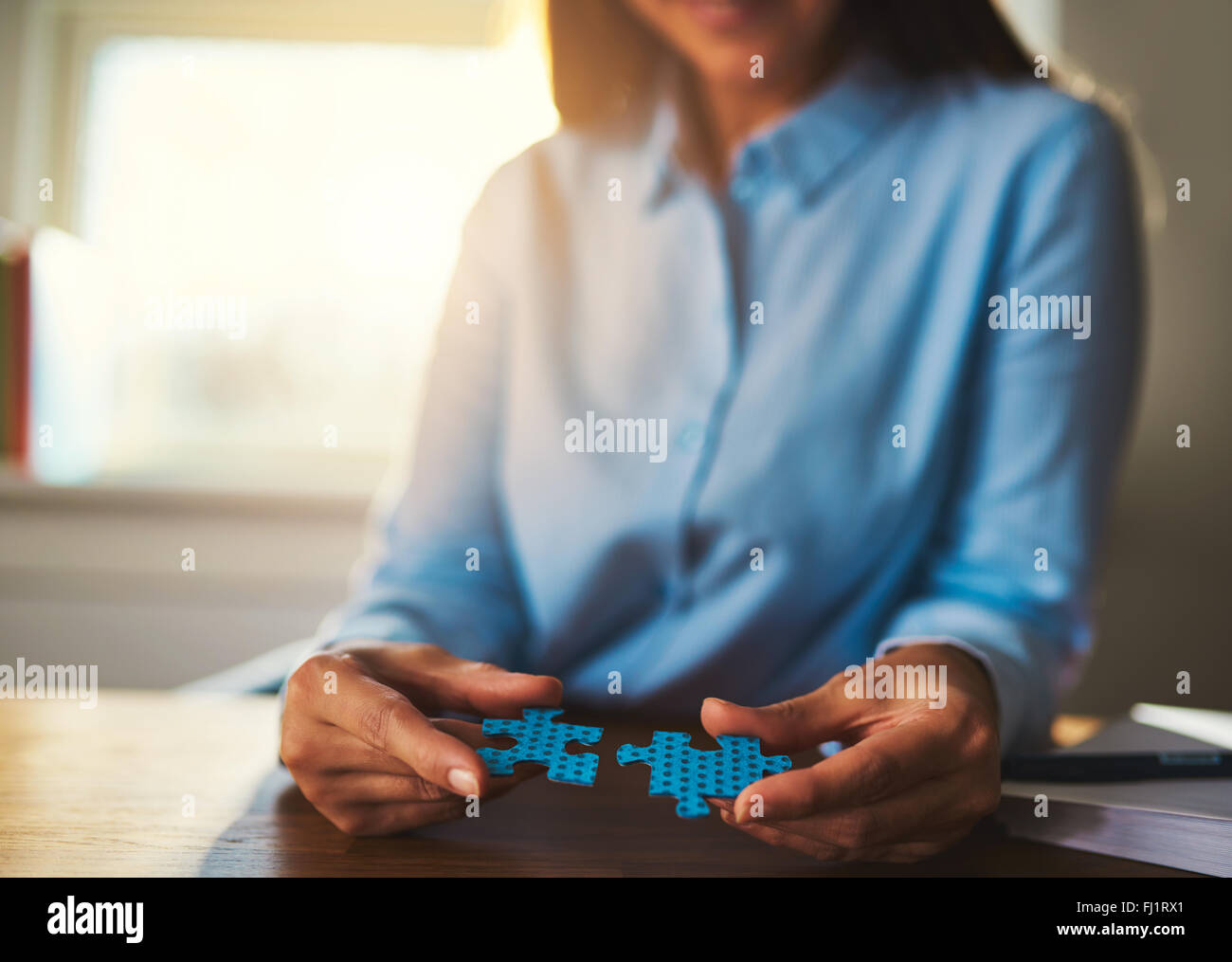 Business woman connecting puzzles, closeup of hands, success concept Stock Photo
