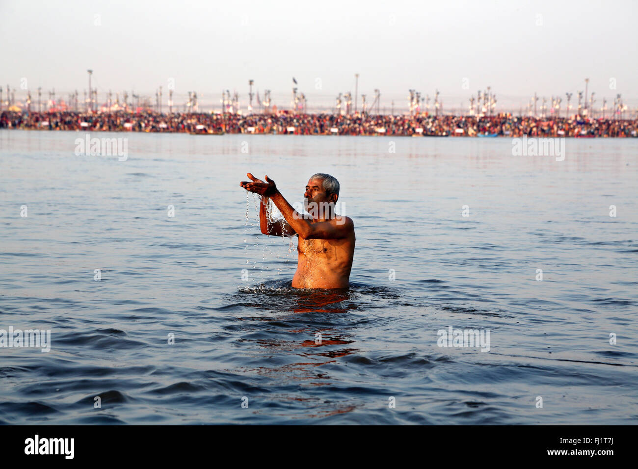 Man praying in the Sangam water, Ganges, during Maha Kumbh mela 2013 Stock Photo