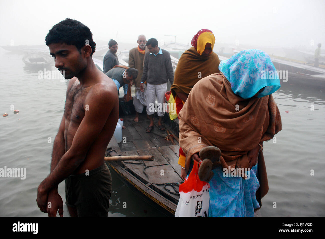 Hindu pilgrims on a ghat of Varanasi , India Stock Photo
