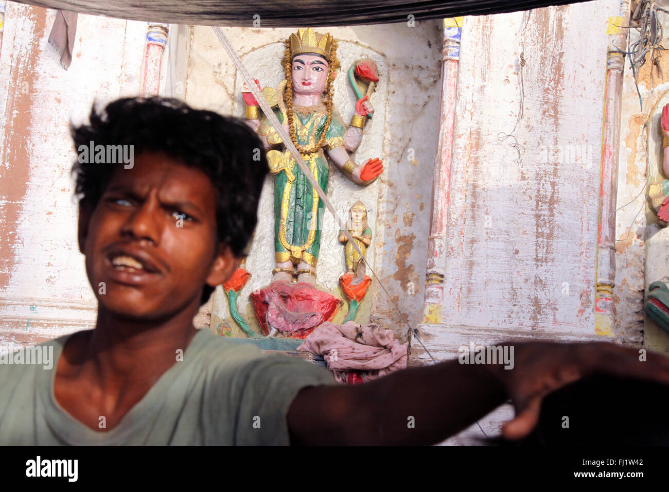 Blind in one eye kid and Hindu Goddess,  Varanasi, India Stock Photo
