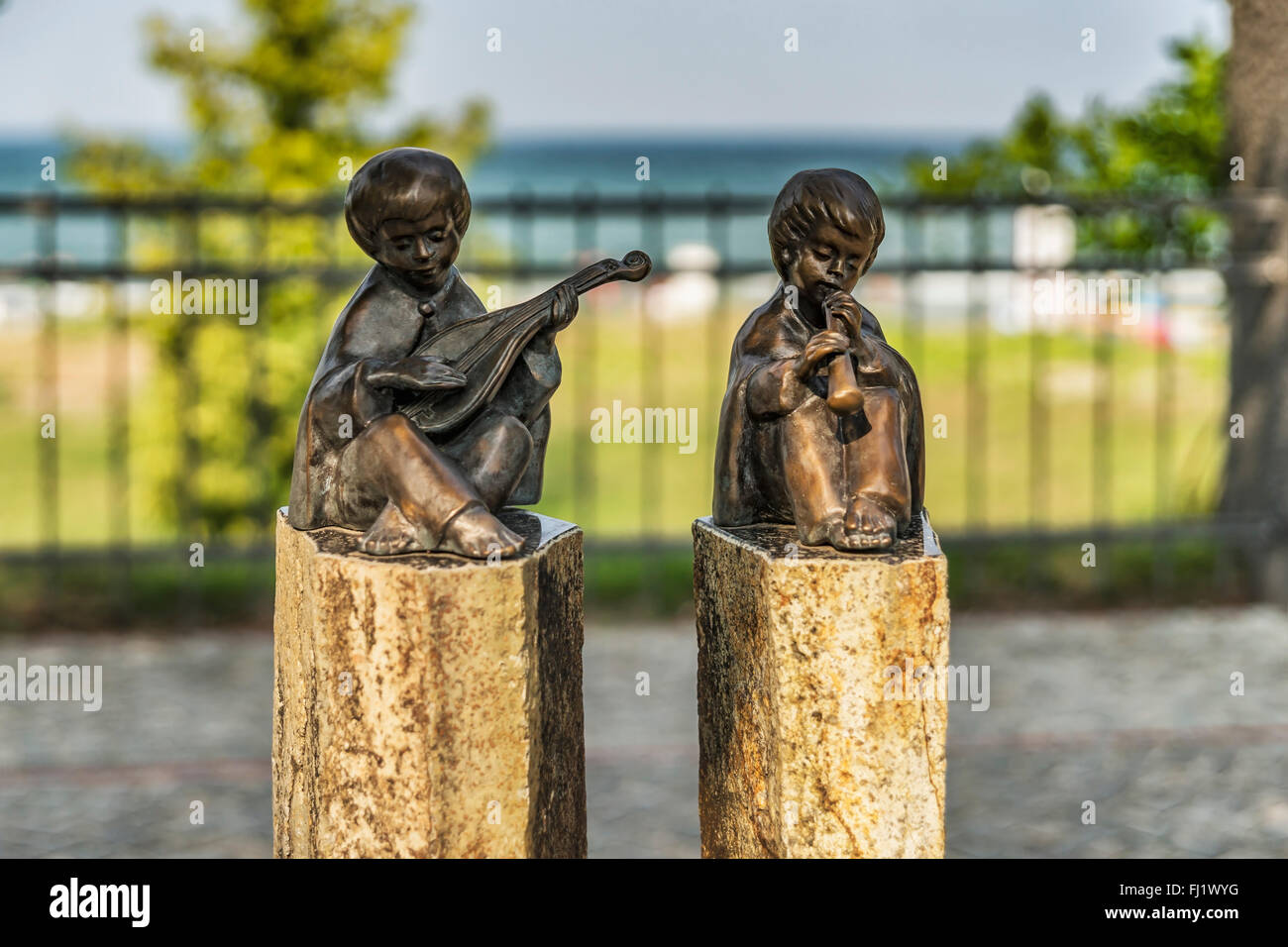 The bronze sculptures lute player and flute player located at the beach promenade from Binz, Ruegen Island, Germany, Europe Stock Photo
