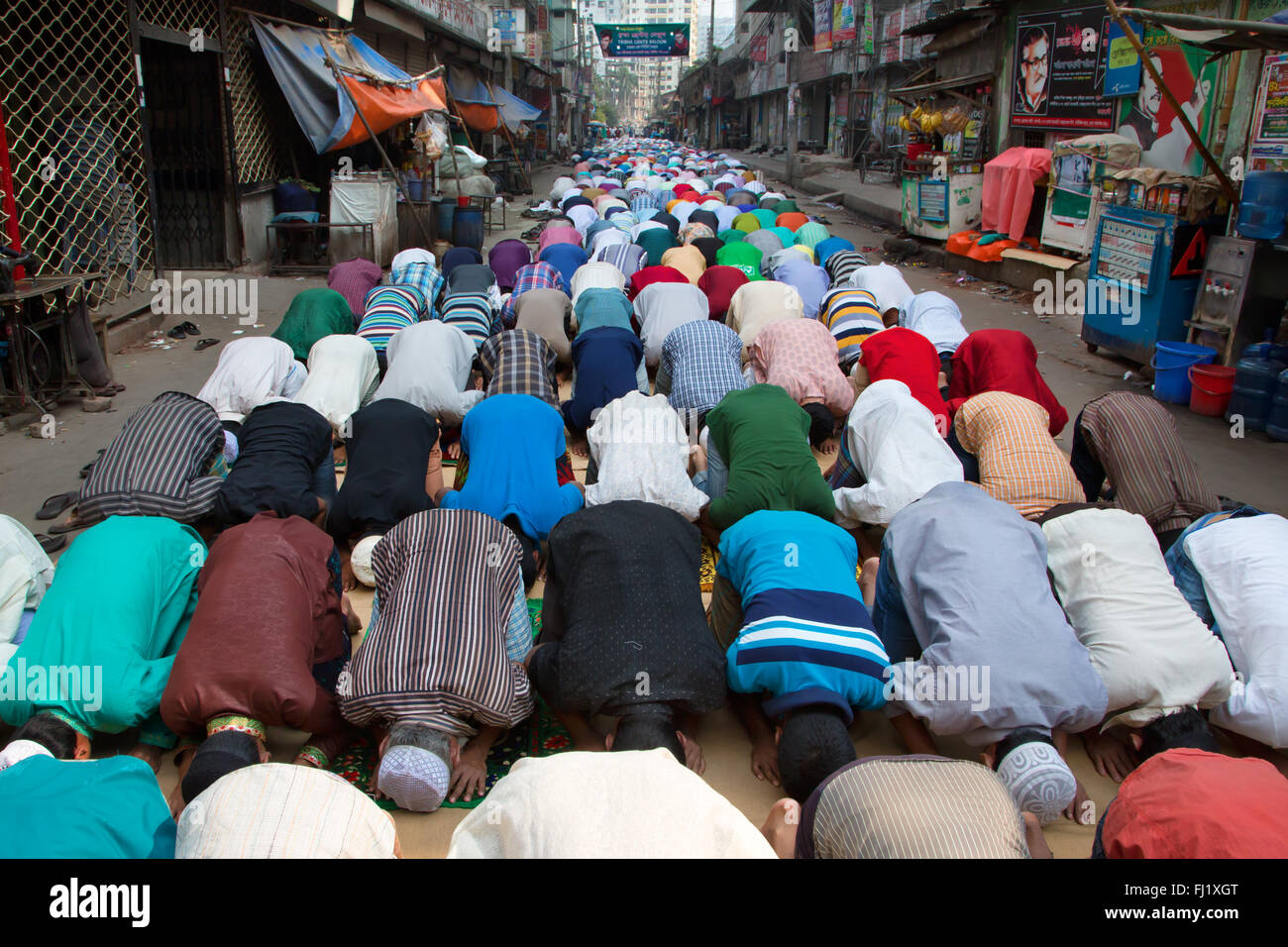 Muslim men pray in a street of Dhaka on Friday afternoon , Bangladesh Stock Photo