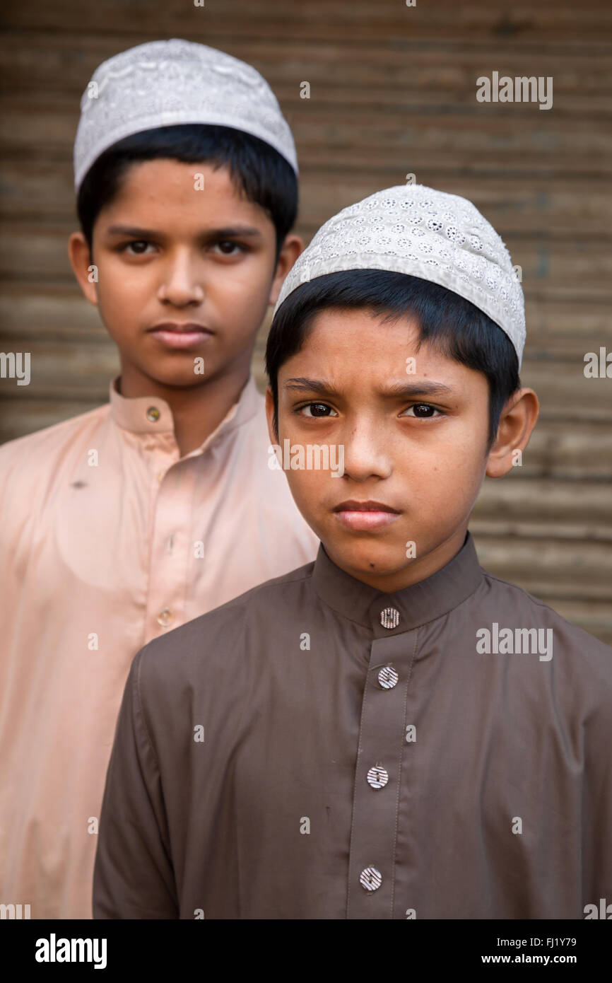 Portrait of Muslim kids with Taqiyah (cap) and traditional dress in Dhaka, Bangladesh Stock Photo
