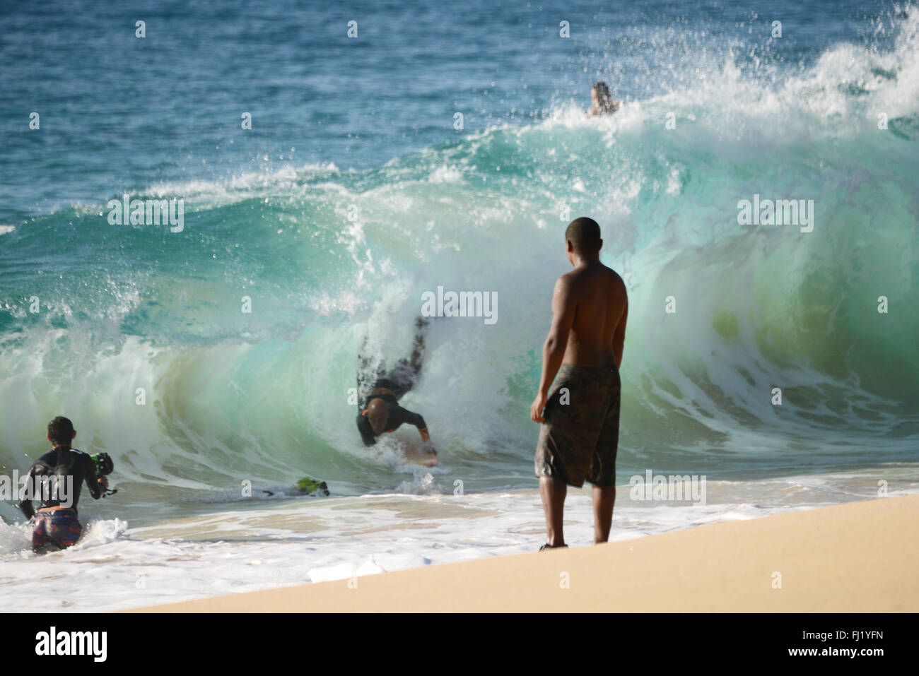 Paddle board surfing of waves breaking on the shore. Stock Photo