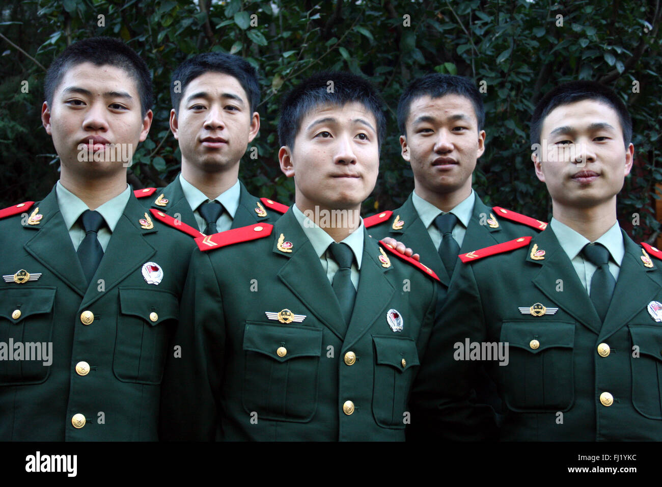 Group of Chinese police officers posing with uniforms in Beijing, China Stock Photo