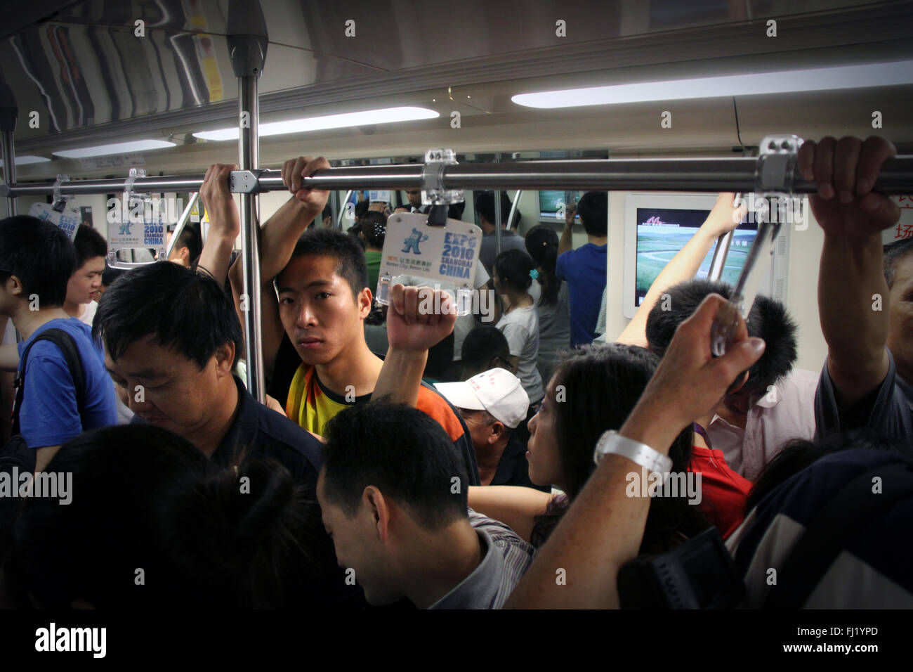 MAN WITH MEGAPHONE PUSH COMMUTERS INTO CROWDED TRAIN SO DOORS WILL CLOSE  RUSH HOUR AT PEOPLE S SQUARE SHANGHAI CHINA Stock Photo - Alamy