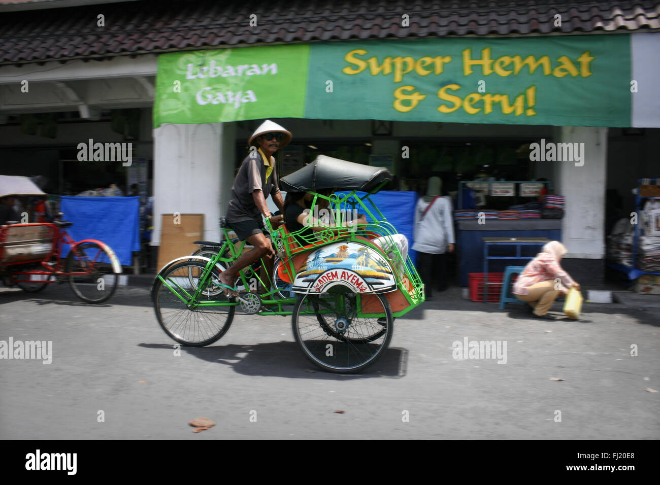 Becak driver in Jakarta, Indonesia Stock Photo