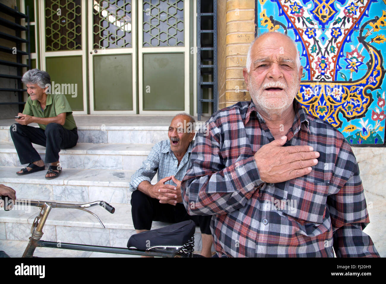 Portrait of Iranian man with hand on his heart as a welcome sign in Yazd, Iran Stock Photo