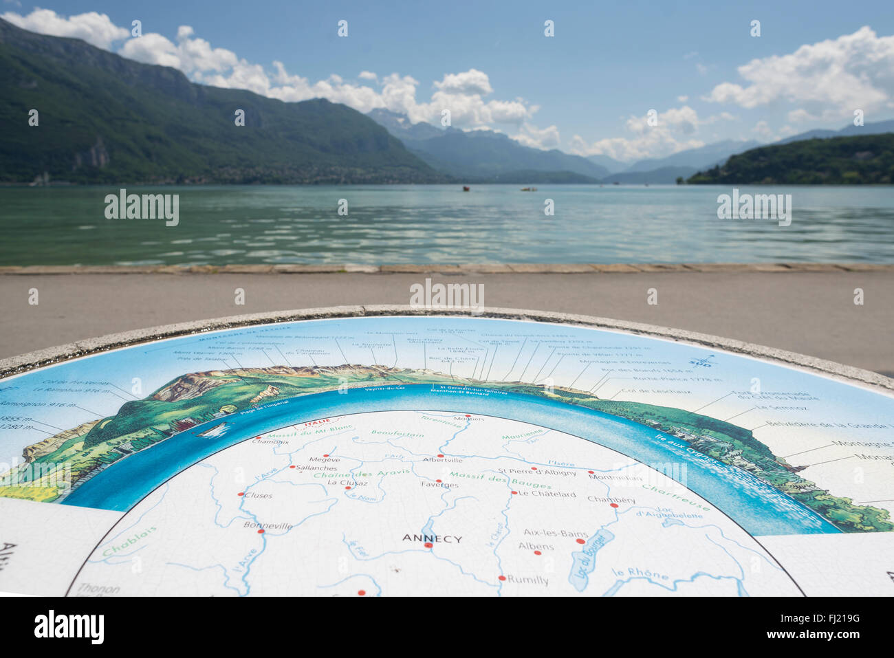 Panoramic map on the lakeside of Annecy with Lake Annecy and surrounding alpine mountains in the background, Savoy, France Stock Photo
