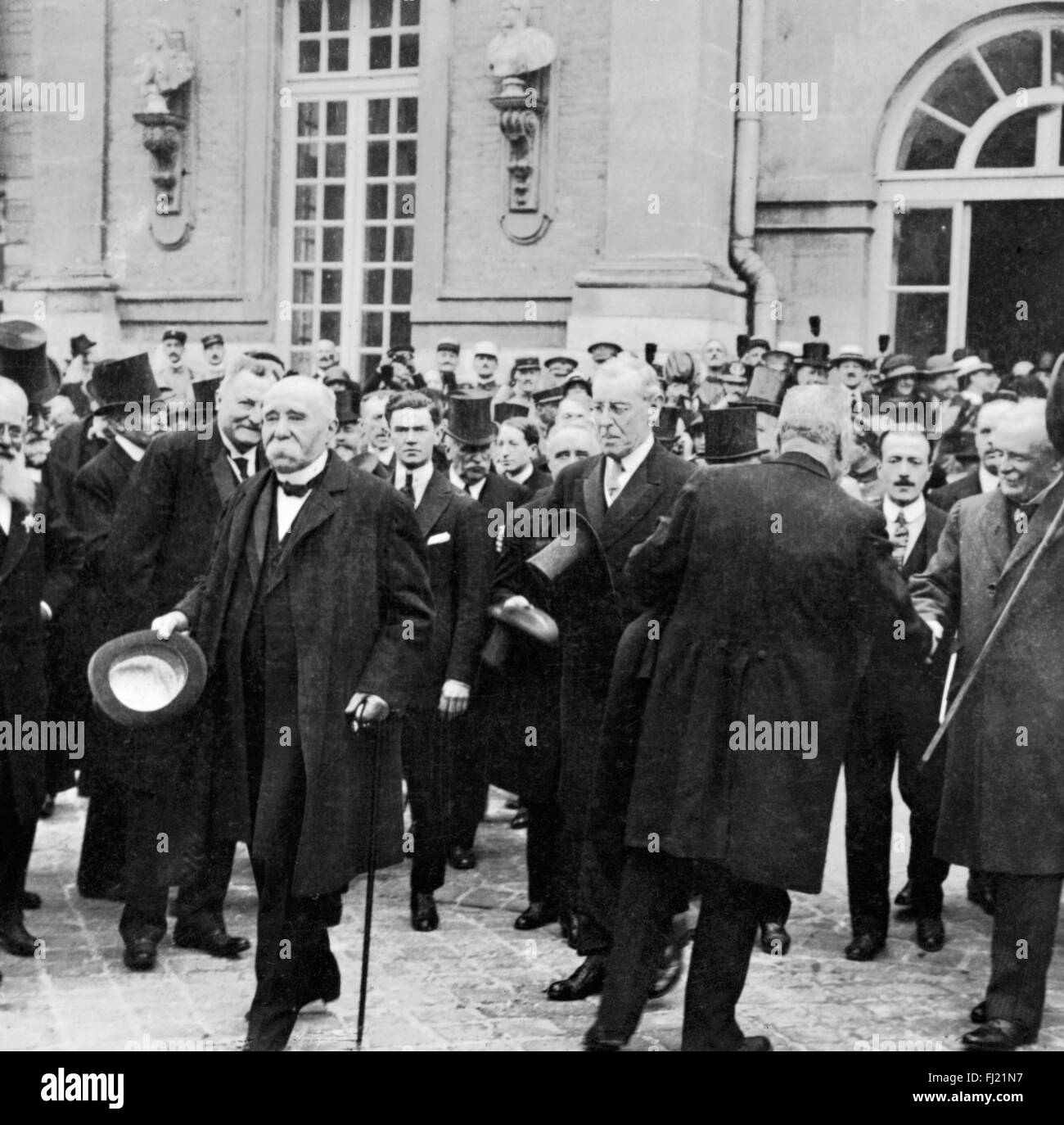 Treaty of Versaille. French Prime Minister Georges Clemenceau, US President Woodrow Wilson and British Prime Minister David Lloyd George leaving the Palace of Versailles after signing the peace treaty on 28 June 1919. Stock Photo