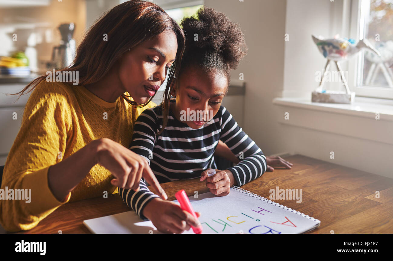 Little black girl learning to read learning the alphabet Stock Photo