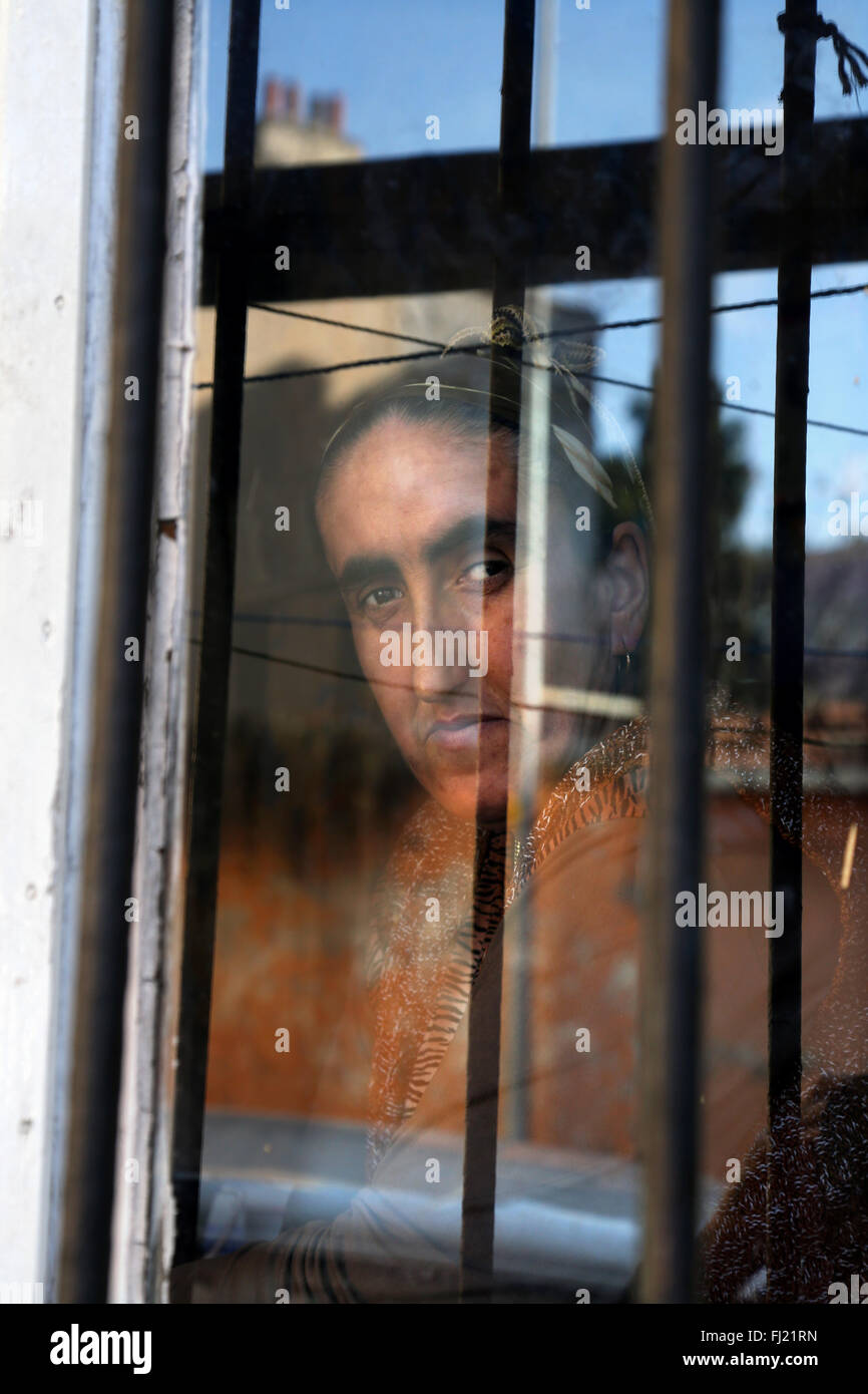 A woman looks through a window in Fatih area , Istanbul Stock Photo