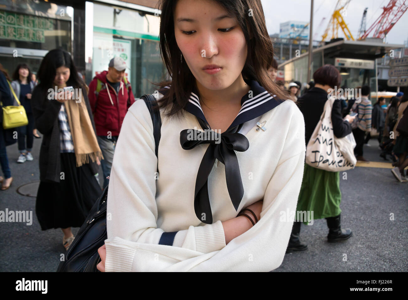 Shy lonely girl in a street of Tokyo, Japan Stock Photo