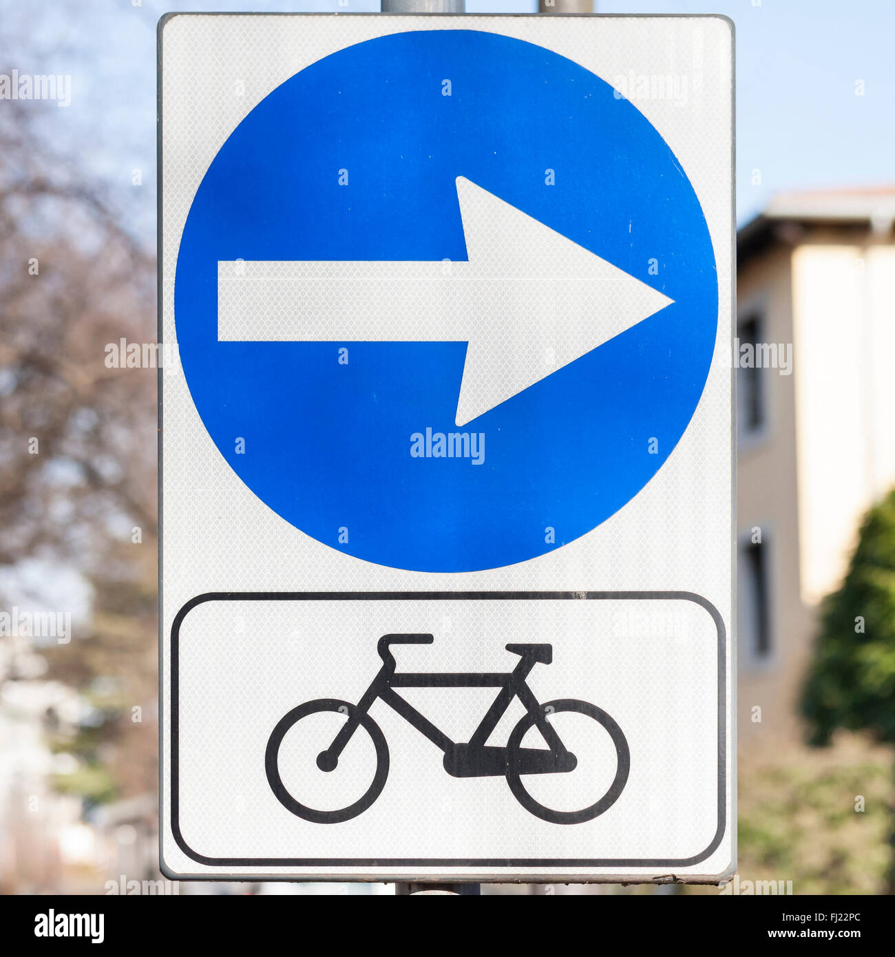 Road sign indicating the direction of the bike path. Stock Photo